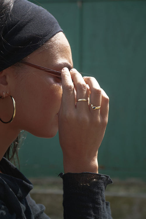 Woman adjusting her sunglasses in bright daylight