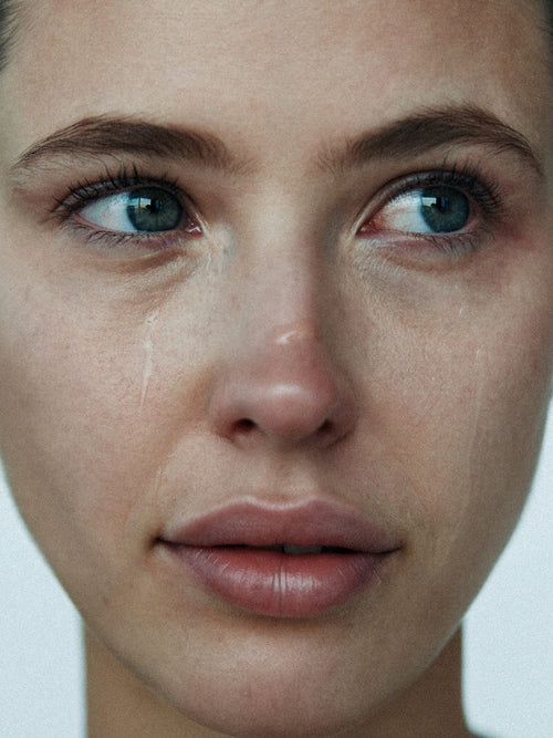 Close up portrait of a woman with blue eyes and bare natural skin
