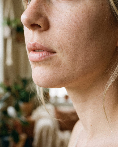 Close up of a woman's face in natural light, skin clear and unretouched