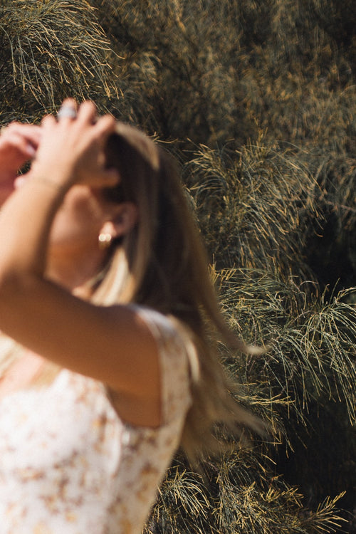Woman enjoying sunshine and greenery outdoors