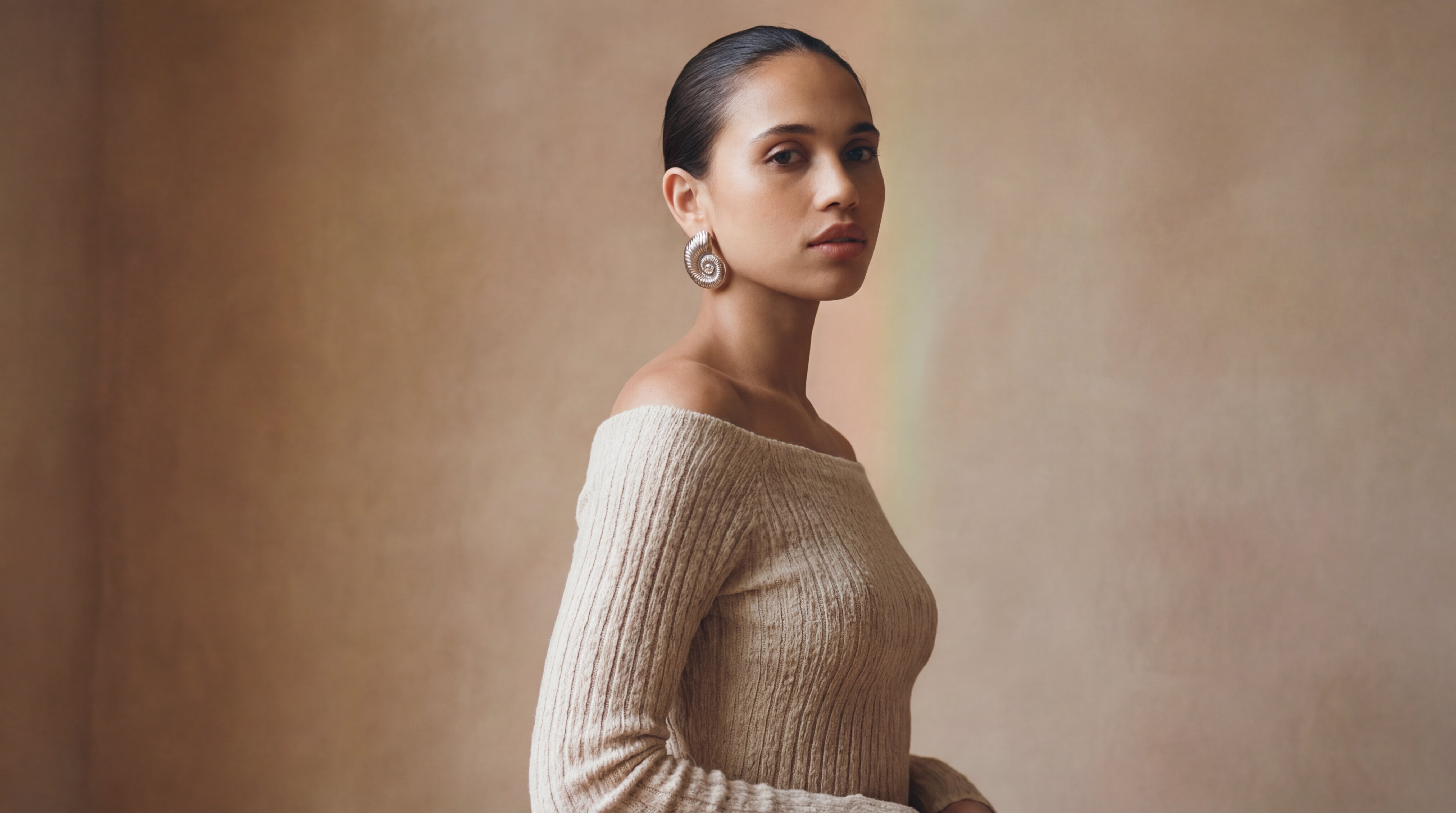 Editorial portrait of a woman with calm, naturally glowing skin in soft, warm natural light.
