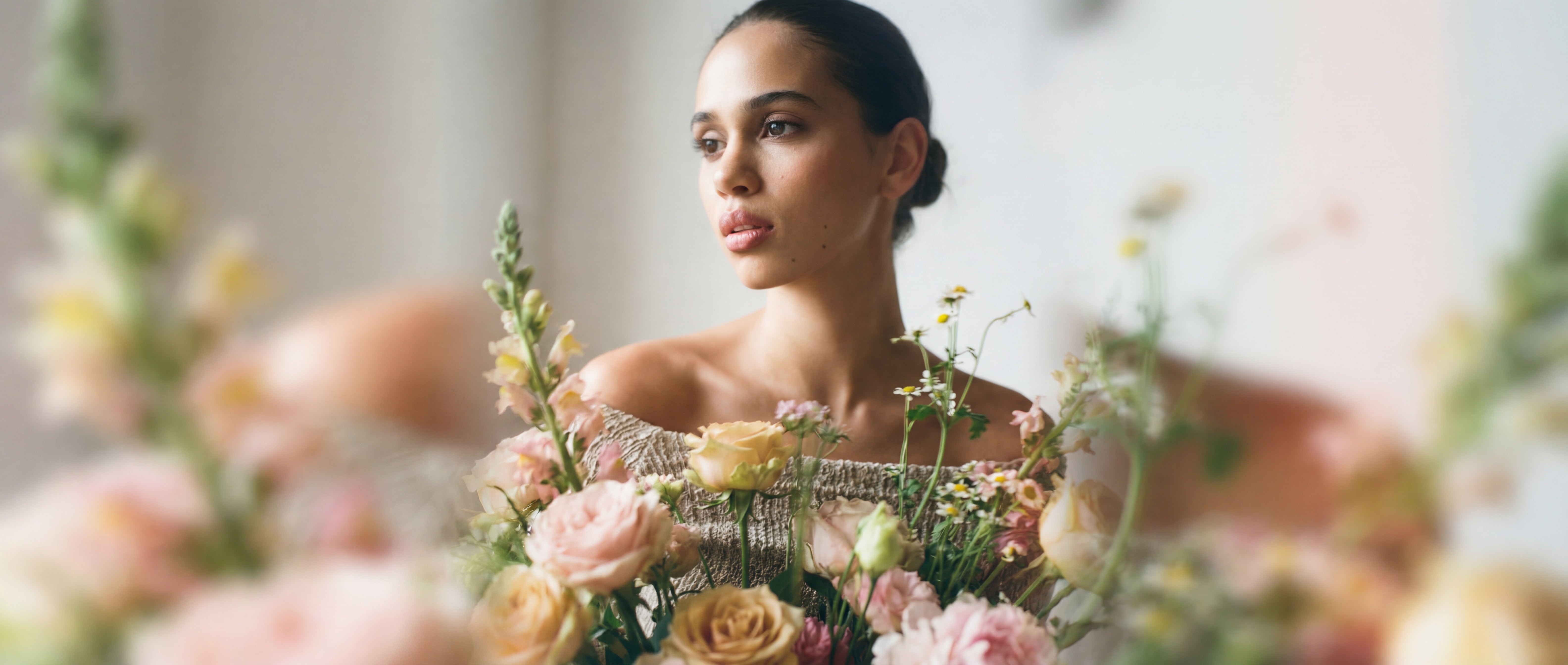 Editorial portrait of a client with calm, luminous skin in soft natural light.