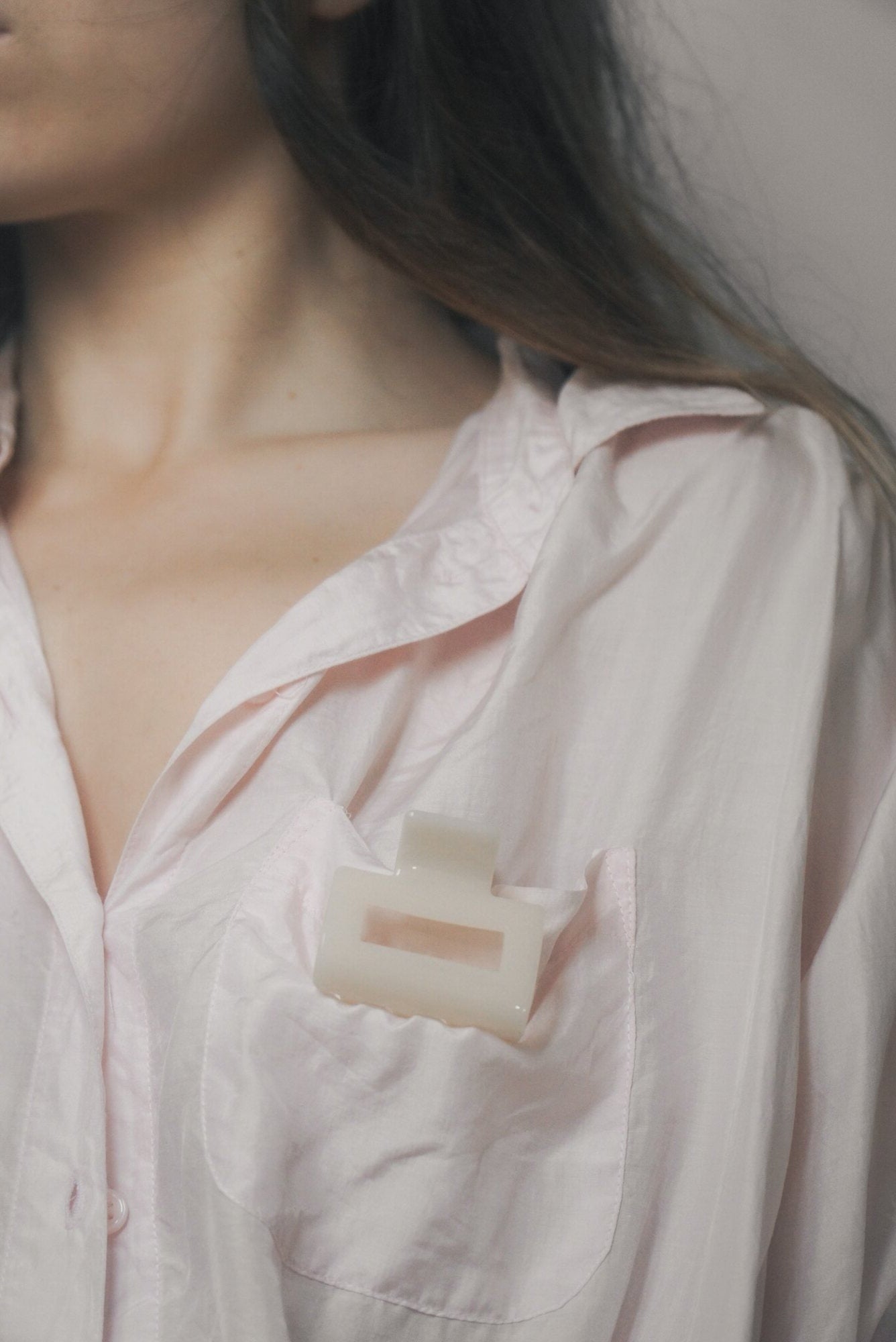 Neck and décolletage in a soft pink shirt, skin tag removal at Pink Laser Clinics in Doncaster