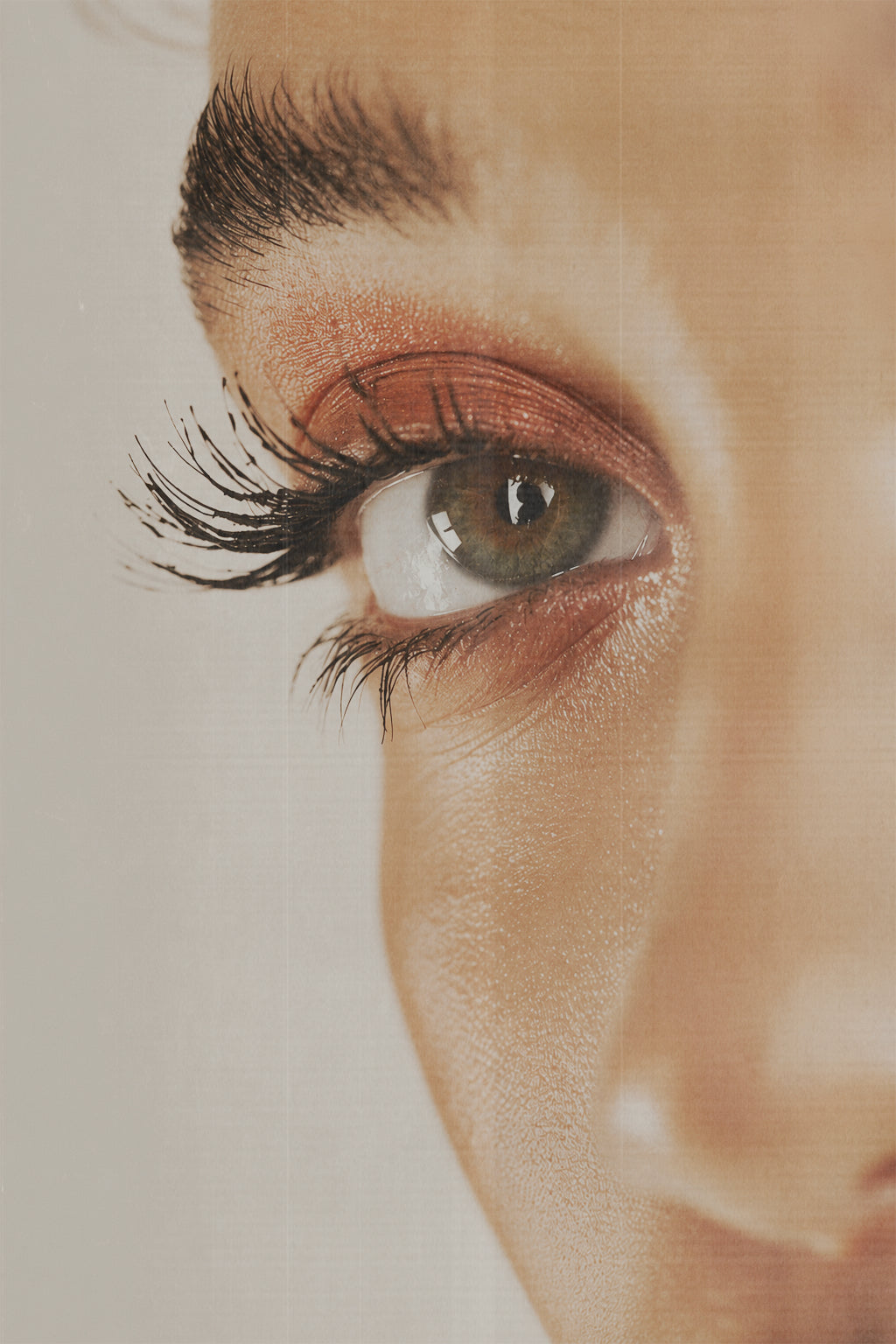 Editorial portrait of a client with calm, luminous skin around the eyes in soft natural light.